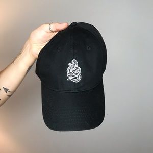 Plain black hat with snake patch on front